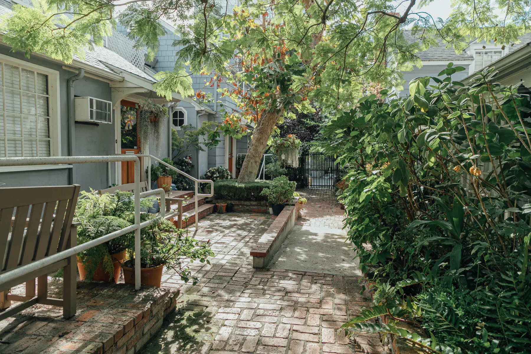 The brick courtyard path leading to the office entrance